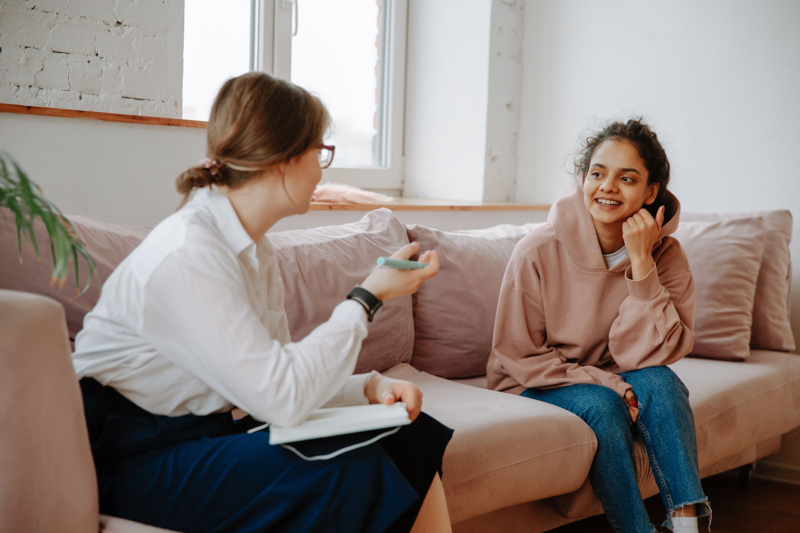 two people talking on a couch