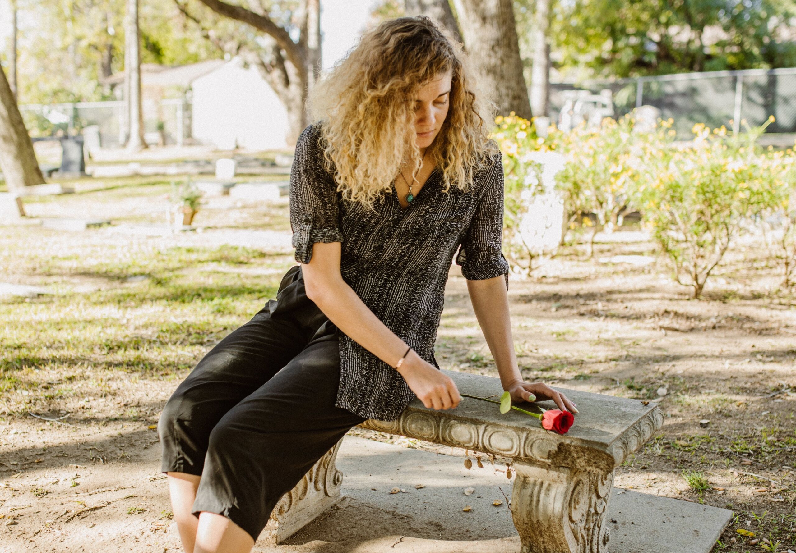 Woman on bench in cemetery