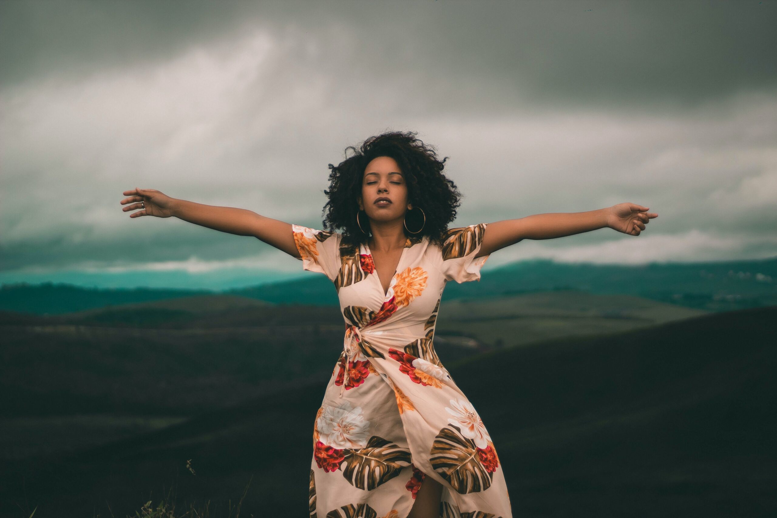 woman standing with her arms wide open