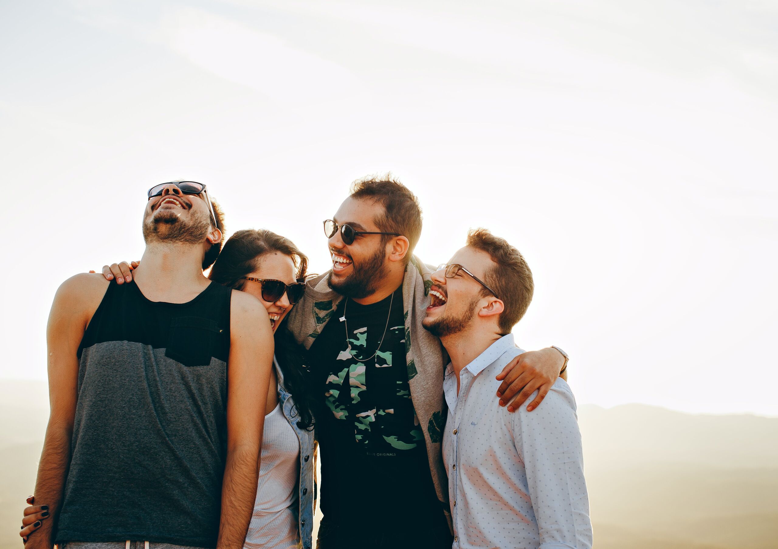 four friends hugging. Service: Family Counselling, Intervention Familiale