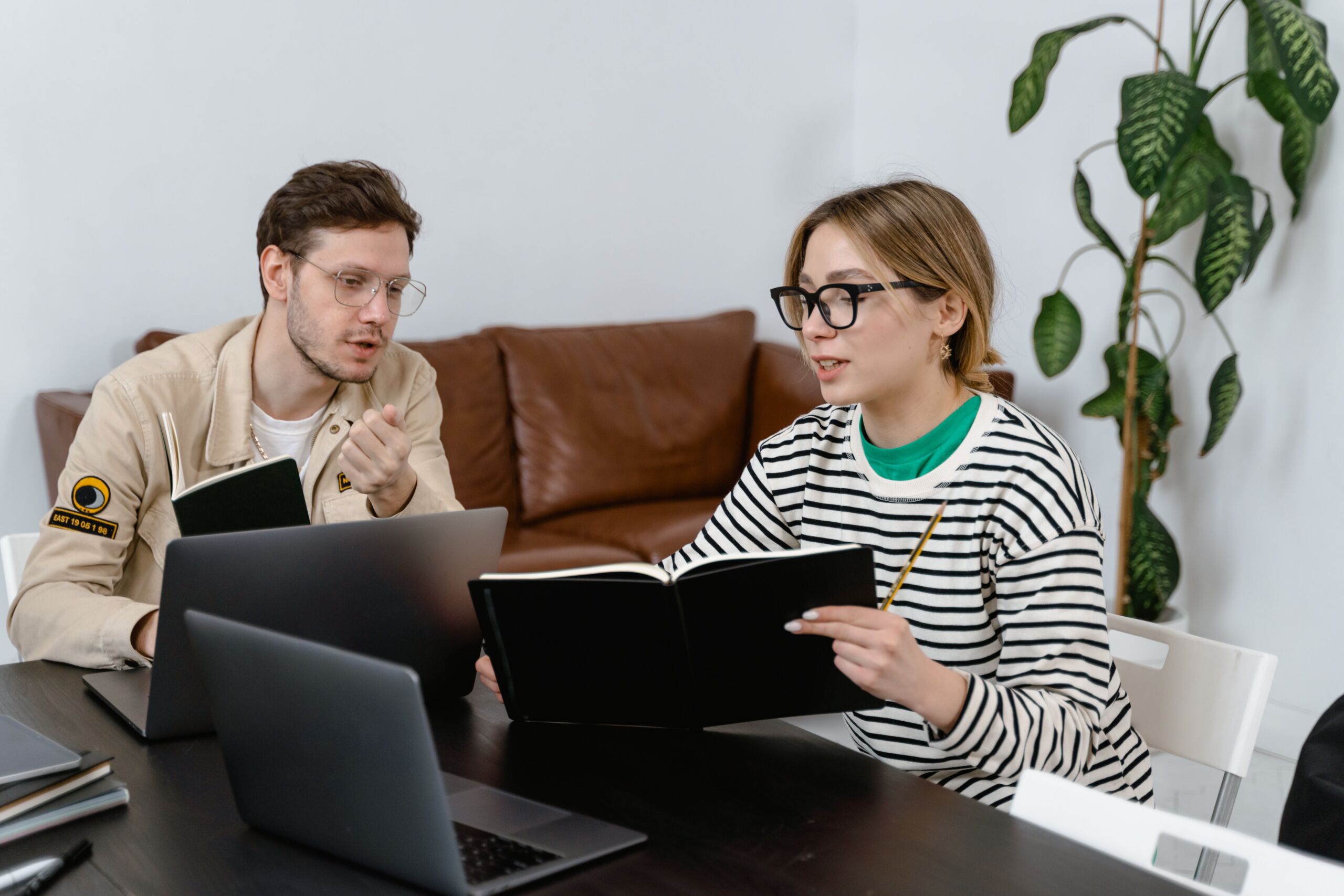 two interns talking at a desk about professional supervision opportunity