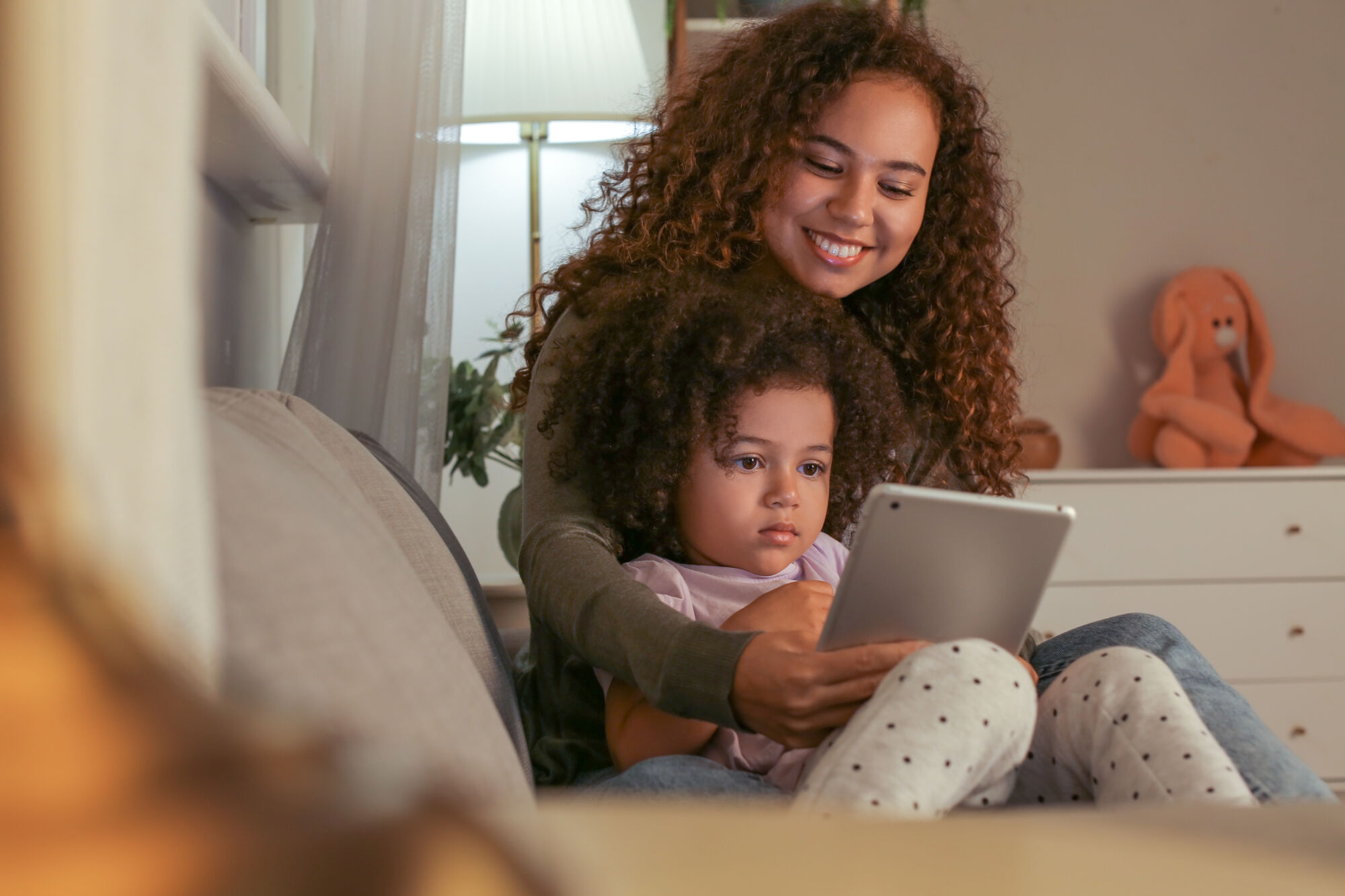 Mother reading daughter a bedtime story